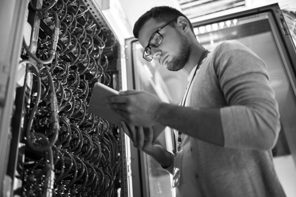 Skilled network engineer working in a server room